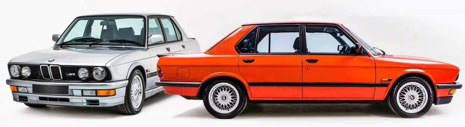 Classic BMW E28 5 Series saloons: a silver M5 and an orange example